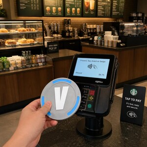 May include: A black Ingenico payment terminal with a screen displaying "Present, Tap, Insert or Swipe" and an amount of $4.75. A circular grey token with a large white letter V and blue accents is held in front of the device near a tap-to-pay sign.