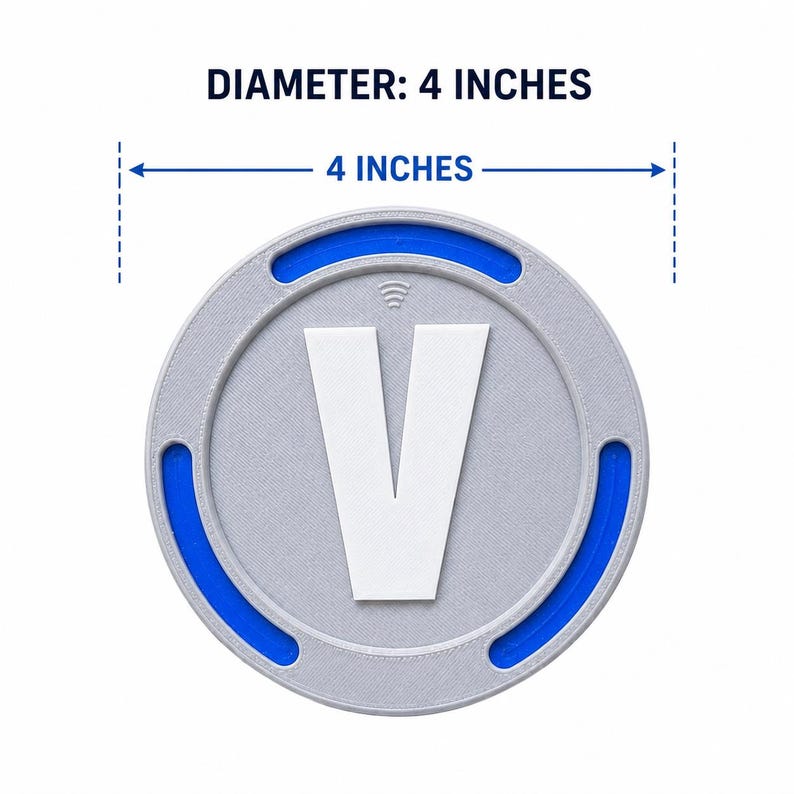 May include: A circular gray token featuring a large white letter V in the center, accented by a blue ring and a small Wi-Fi symbol icon above the letter. The text DIAMETER: 4 INCHES is displayed above the object, which measures 4 inches across.
