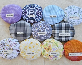 Microwavable round grain-filled natural heating pad with washable cover