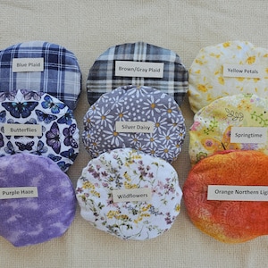 Microwavable round grain-filled natural heating pad with washable cover