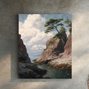 Puede incluir: Una pintura de paisaje representa una escena costera con un acantilado rocoso, un árbol y agua bajo un cielo nublado. La pintura está colgada en una pared de hormigón, con una tumbona y una pequeña mesa delante.