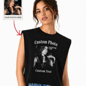 May include: A black sleeveless crop top featuring a custom graphic print on the front. The design includes the text Custom Photo at the top, a black and white photograph in the center, and the text Custom Text at the bottom. A small inset box shows a sample photo with the label YOUR PHOTO HERE.