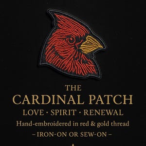 May include: Embroidered patch featuring a red and gold cardinal bird design. The patch is outlined in black and includes the text "THE CARDINAL PATCH LOVE SPIRIT RENEWAL" and "IRON-ON OR SEW-ON".