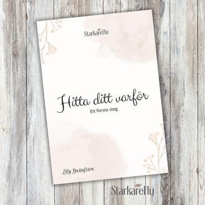 May include: A softcover book with the title "Hitta ditt varför" in elegant script, with the subtitle "Ett första steg." The cover features a watercolor-style pink wash and floral accents. The author's name, Lilly Gustafsson, is also visible.