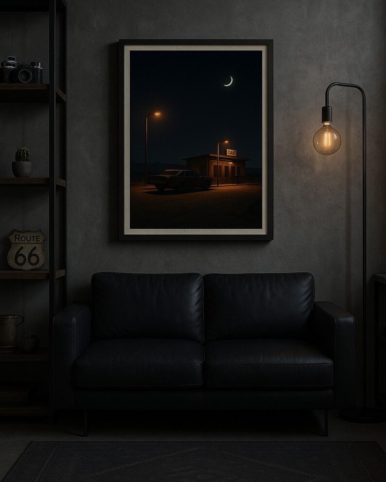 May include: Framed art print depicting a nighttime scene with a crescent moon and a building with the word "GAO" illuminated. A car is parked in front of the building. The print hangs above a black leather sofa. A Route 66 sign is visible on a shelf.