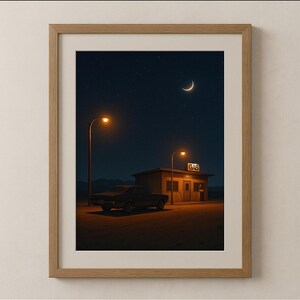 May include: Framed art print depicting a vintage car parked near a gas station at night. The scene is illuminated by streetlights and the moon. The gas station sign reads "GAS". The sky is dark with visible stars.