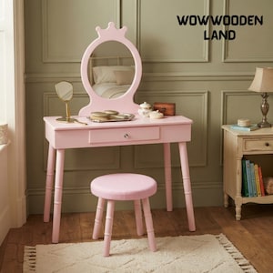 May include: A light pink wooden vanity table with a crown-shaped mirror and a matching round stool. The table features a single drawer with a silver knob. The text WOWWOODEN LAND is visible in the upper right corner of the image.