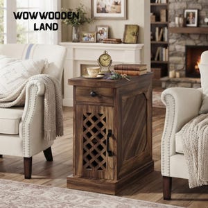 May include: A narrow wooden end table with a dark brown finish, featuring a single top drawer with a round black knob and a lower cabinet door with a diamond-patterned lattice cutout and a vertical black handle, positioned between two armchairs.