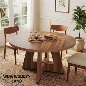 May include: A round wooden dining table with a dark brown grain finish and a geometric pedestal base. The table is set with a ceramic teapot, two matching cups on a woven mat, two stacked books, and a tall yellow candle. Text reads WOWWOODEN LAND.