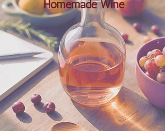 May include: A book cover titled "She Pours: A Beginner's Guide to Homemade Wine" with a clear glass bottle filled with pink liquid. The image includes grapes, a wooden spoon, and a bowl of fruit, suggesting a theme of winemaking.