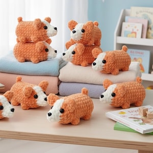 May include: A collection of seven small, handmade crochet corgi plush toys. Each plush features a textured orange and white yarn body, small upright ears, a short tail, and black plastic bead eyes. The corgis are arranged in various positions.