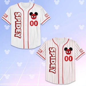 May include: Two white baseball jerseys with red accents and the word "SPIDEY" vertically down the front. One jersey has a solid white background, the other has red pinstripes. Both feature a Spider-Man Mickey Mouse emblem and the number "00".