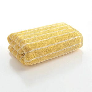May include: Folded yellow bath towel with white horizontal stripes. The towel is made of a soft, absorbent material, perfect for use in a bathroom or spa setting. The bright color and simple design make it a versatile addition to any decor.