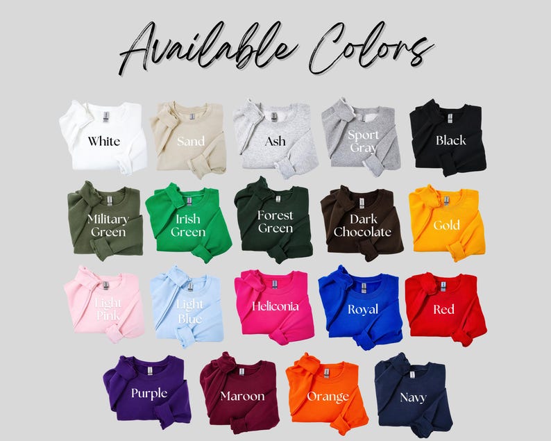 May include: A display of crewneck sweatshirts in various colors, including white, sand, ash, sport gray, black, military green, Irish green, forest green, dark chocolate, gold, light pink, light blue, heliconia, royal, red, purple, maroon, orange, and navy. The text "Available Colors" is at the top.
