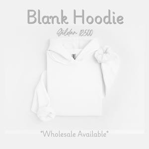 May include: A white blank hoodie with the text "Blank Hoodie" and "Gildan 18500" in gray. The sleeves are cuffed, and the hood is up. The words "Wholesale Available" are at the bottom.