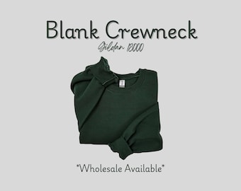 May include: A dark green blank crewneck sweatshirt, folded neatly. The text "Blank Crewneck" is displayed above the sweatshirt, with "Gildan 18000" below it. The words "Wholesale Available" are at the bottom.