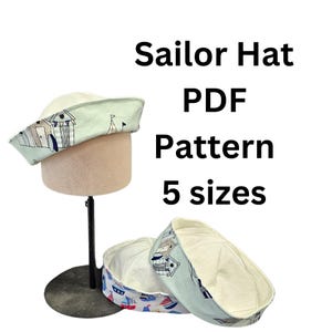 May include: A PDF pattern for a sailor hat in five sizes. The pattern features a light blue and white design with a nautical theme. The hat is shown on a mannequin.