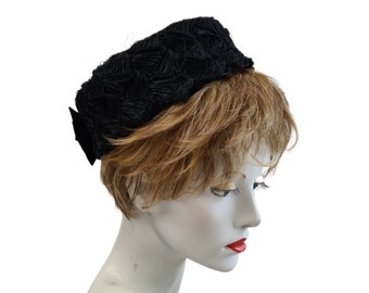 Black pillbox hat made with vintage crochet straw, Jackie O style with velvet ribbon bow, average size , comb fixing, made in UK