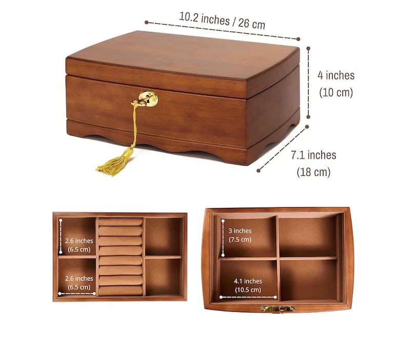 May include: A wooden jewelry box with a curved top, measuring 10.2 inches long, 4 inches high, and 7.1 inches deep. It features a gold-colored lock and a decorative tassel. The interior includes compartments and ring slots.