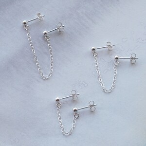Two stud earrings connected by chain Clearance