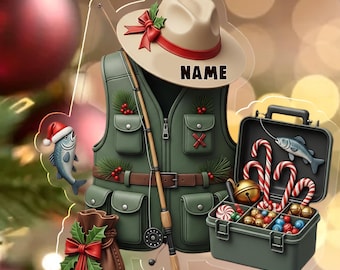 May include: A Christmas ornament featuring a fishing theme. The ornament includes a fishing vest, a hat with the word "NAME", a tackle box with candy canes, and a fishing rod. The ornament is decorated with holly and a small fish wearing a Santa hat.