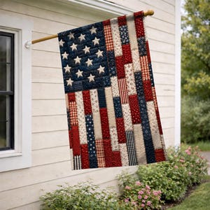 May include: A decorative flag featuring a patchwork design of the American flag. The canton is dark blue with white stars, and the stripes are composed of vertical fabric strips in various red, white, and blue patterns, including florals and checks.