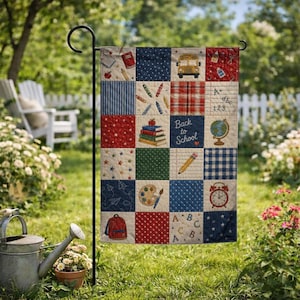 May include: A rectangular garden flag featuring a patchwork design with school-themed illustrations including a yellow bus, a globe, a red backpack, an alarm clock, pencils, and the text "Back to School" and "A+ abc 123" on a multi-colored grid.