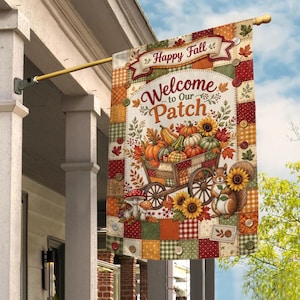 May include: A rectangular garden flag featuring a patchwork border with button accents. The center displays a wooden wagon filled with pumpkins and gourds, a squirrel holding a sunflower, and the text Happy Fall Welcome to Our Patch.