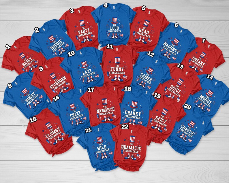 May include: A selection of red and blue t-shirts, each emblazoned with the words "The Firecracker" and a descriptive adjective. The shirts feature a firework graphic and phrases such as "Party," "Lazy," and "Sneaky."