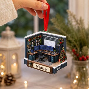 May include: A flat, hexagonal-shaped ornament featuring a detailed illustration of a software engineer's office workspace. The scene includes a desk, computer monitors, a chair, and a Christmas tree. The text reads SOFTWARE ENGINEER, BUILD, SOLVE, IMPROVE, CODE, DEBUG, DEPLOY, REPEAT, Name, and 202X.