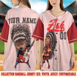 May include: A light pink baseball jersey with vertical pinstripes and red sleeves. The front features the name Ash, the number 00, and a graphic of a hedgehog playing a red electric guitar. The back displays the text YOUR NAME above a hedgehog.