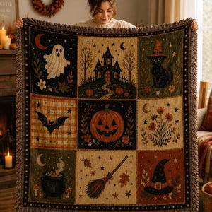 May include: A woven throw blanket featuring a grid of nine Halloween-themed panels. The design includes a ghost, a haunted house, a black cat in a witch hat, a bat, a jack-o'-lantern, autumn flowers, a bubbling cauldron, a broom, and a witch hat.