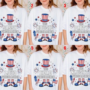 May include: White t-shirts with patriotic designs. Each shirt features a red, white, and blue top hat, fireworks, stars, and the text "The Sassy Firecracker", "The Bougie Firecracker", "The Party Firecracker", "The Loud Firecracker", "The Head Firecracker", and "The Naughty Firecracker".