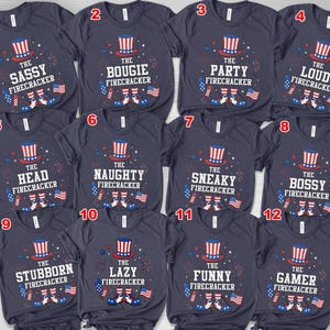 May include: Navy blue t-shirts with various phrases and graphics related to fireworks and the Fourth of July. Each shirt features a top hat, fireworks, and American flags. Phrases include "The Sassy Firecracker" and "The Bougie Firecracker."