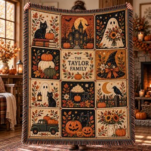 May include: A woven throw blanket featuring a grid of autumn-themed illustrations including a black cat, a haunted house, a ghost, pumpkins, a witch hat, a crow, and a truck. The center panel displays the text THE TAYLOR FAMILY with a pumpkin.