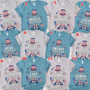 May include: A selection of twelve short-sleeved t-shirts with different phrases related to fireworks. Each shirt features a patriotic Uncle Sam hat, fireworks, and the American flag. The phrases include "Sassy," "Bougie," and "Gamer."