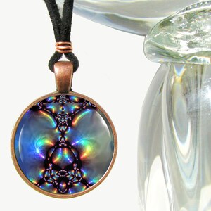 May include: A round copper pendant necklace with a colorful iridescent image inside. The image is abstract and features a swirling pattern of blues, purples, and greens.
