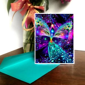 May include: A colorful abstract art print of a butterfly with a human-like figure in the center. The butterfly is surrounded by a dark background with water droplets.