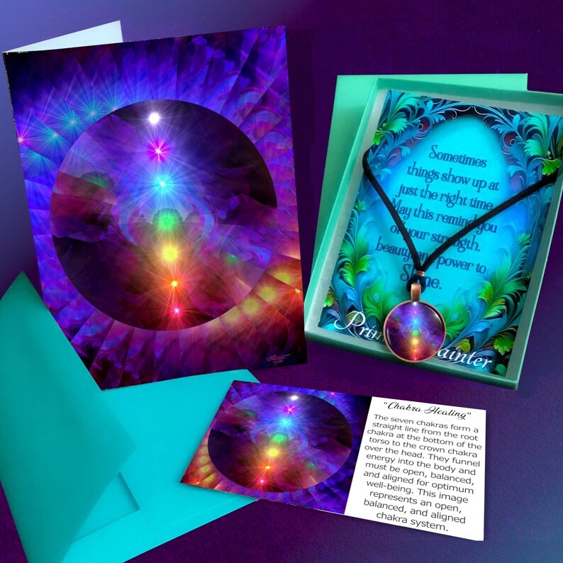 May include: A round pendant necklace with a seven-chakra design on a black cord, presented in a teal gift box with a card featuring the text: Sometimes things show up at just the right time. May this remind you of your strength, beauty and power to shine.