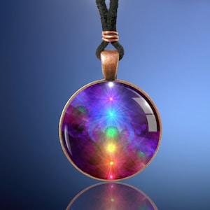 Chakra Necklace, Rainbow Pendant, Original Reiki Energy Artwork by Primal Painter. Close up photo against a blue background