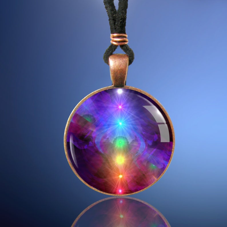 Chakra Necklace, Rainbow Pendant, Original Reiki Energy Artwork by Primal Painter. Close up photo against a blue background