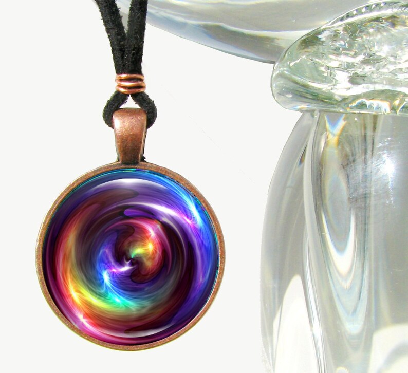 colorful round necklace featuring rainbow swirl chakra art sealed under glass