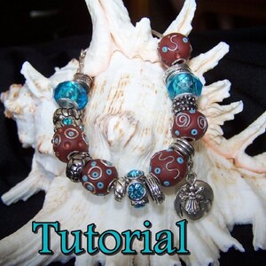 May include: A brown and blue charm bracelet with a silver angel charm. The bracelet is on a white seashell background. Tutorial.