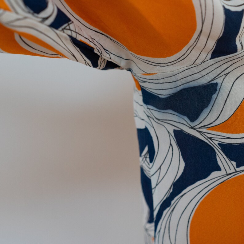 ML 1970s orange and blue abstract blouse 70s vintage pussy bow draped button-front rayon shirt with abstract floral print