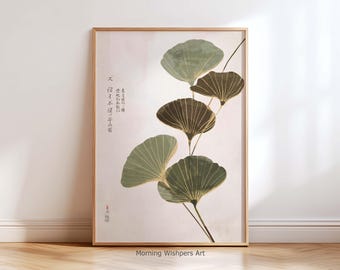 Puede incluir: Lámina artística enmarcada con hojas de ginkgo estilizadas en tonos verdes y marrones con detalles dorados. Caracteres japoneses y un sello rojo visibles a la izquierda. La obra tiene un fondo neutro y un marco de madera.