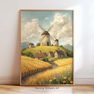 Op de afbeelding: Een ingelijste prent van een landelijk landschap met windmolens op een heuvel, omringd door tarwevelden en kleine huizen. Het kunstwerk heeft een warm kleurenpalet met een blauwe lucht en witte wolken. De tekst "Morning Wishpers Art" staat onderaan.