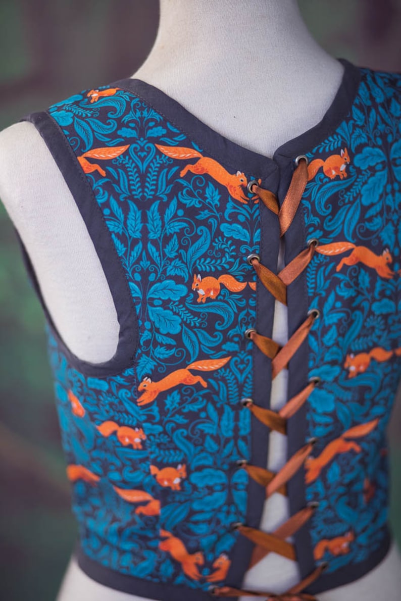 May include: A sleeveless vest with a blue and teal floral pattern featuring orange squirrels. The vest has a brown ribbon lacing up the back.
