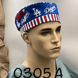 May include: A blue and white patterned scrub cap featuring the Los Angeles Dodgers logo and script. The cap has a red, white, and blue striped band. The text "0305 A" is visible on the scrub top.