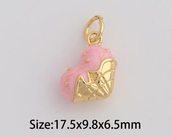 May include: A gold-colored charm with a pink heart-shaped top and a gold-colored waffle cone base. The charm measures 17.5mm x 9.8mm x 6.5mm. The charm has a small loop at the top for attaching to a necklace or bracelet.