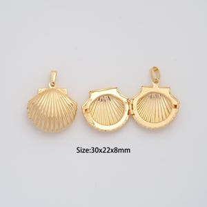 May include: Three gold-colored seashell pendants. One is closed, and two are open, revealing the interior design. The text "Size: 30x22x8mm" is visible. The pendants are approximately 1.18 x 0.87 x 0.31 inches.